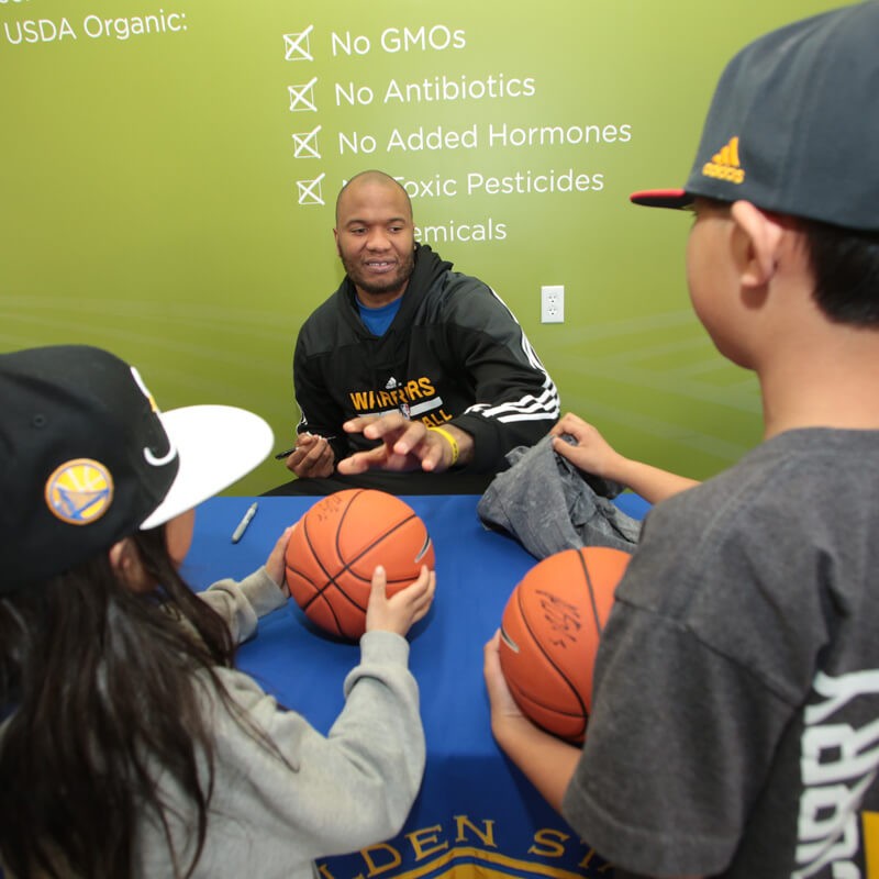 Marreese Speights signing basketballs