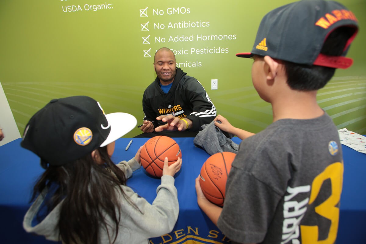 Marreese Speights signing basketballs